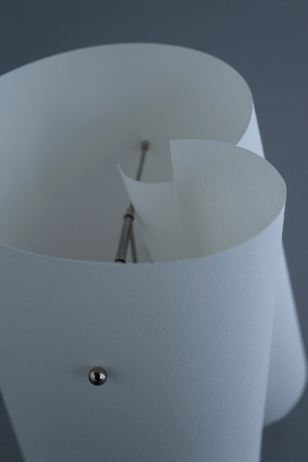 Close-up looking into the shade, the paper curling around the inner frame